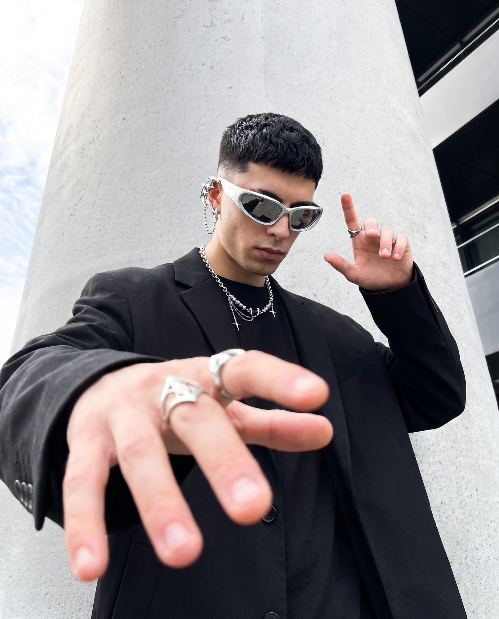 Low angle at a concrete column, wearing the Anarchy Necklace, Saber Ear Cuff, Zenith Ring and Splinter Ring