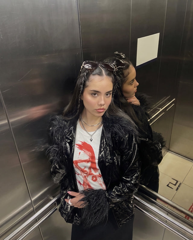 Flash photo in a steel lift, wearing the Bladepoint Necklace