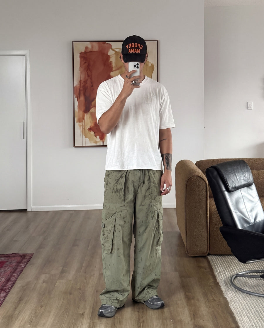 Mirror selfie in cargos, wearing the Razor Ring