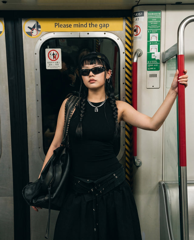 Metro carriage doors, wearing the Blackout Necklace